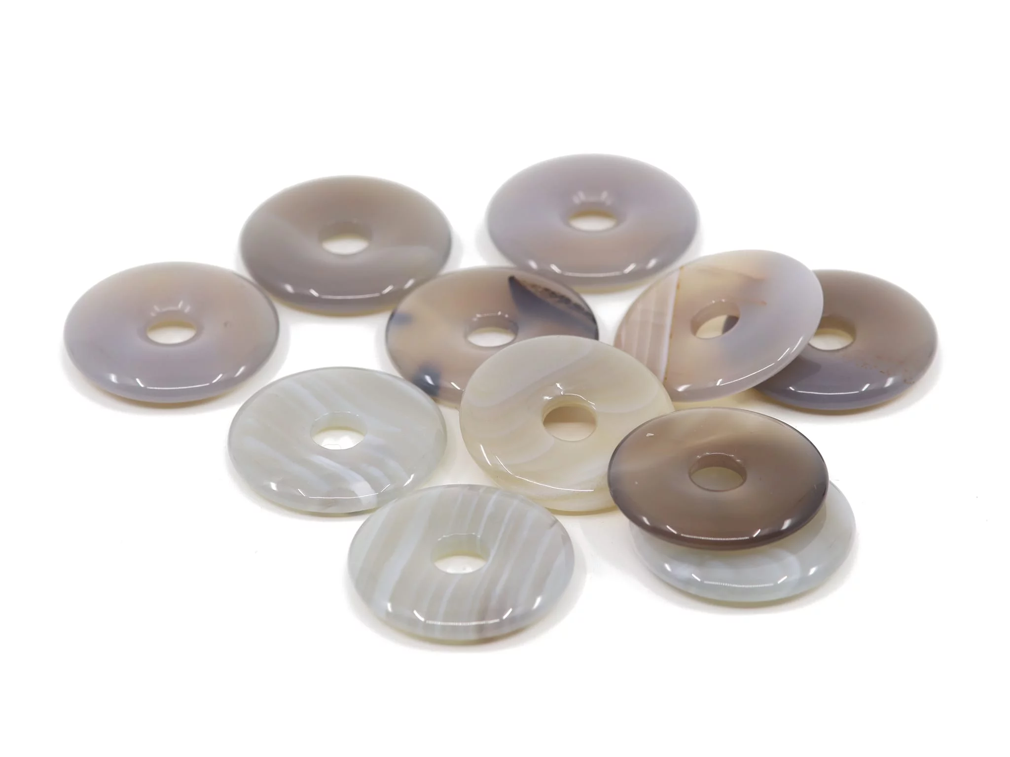 Ciondolo donut in pietra preziosa di agata come selezione di più pietre lucidate in colori naturali