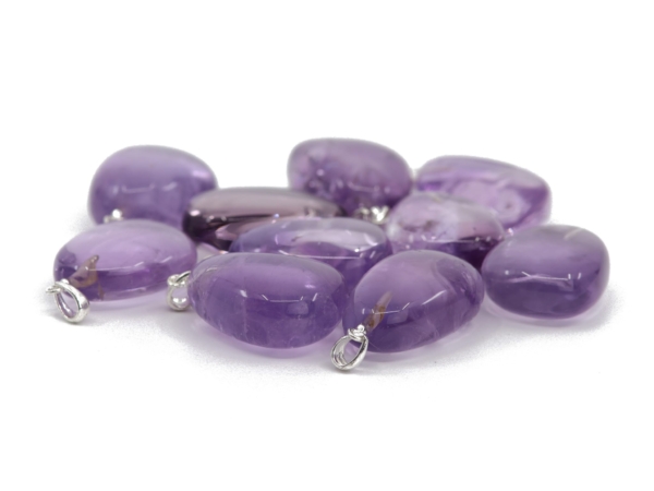 Amethyst gemstone pendant in flat side view with visible silver eyelets