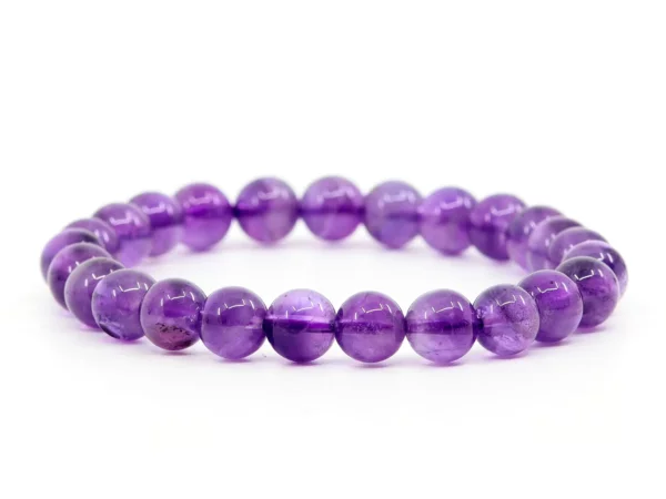Amethyst gemstone bracelet with purple beads on white background in full view