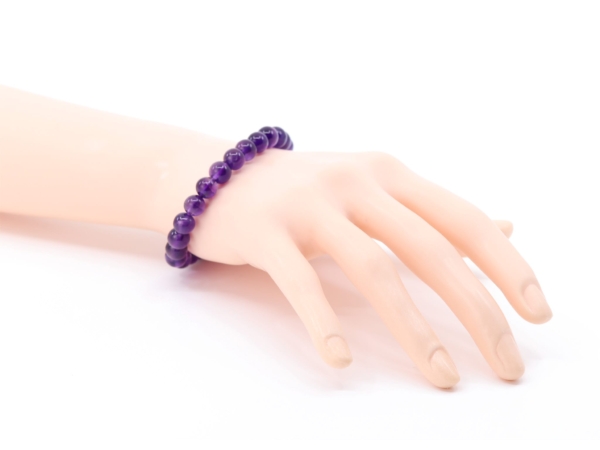 Amethyst gemstone bracelet shown worn on wrist with purple beads