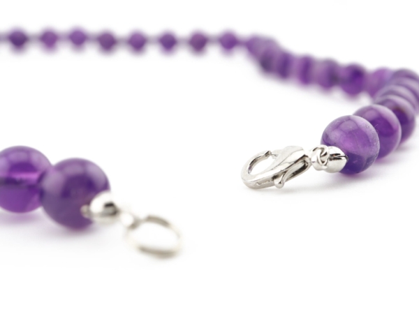 Amethyst necklace with silver-colored lobster clasp as a detailed view of the violet beads