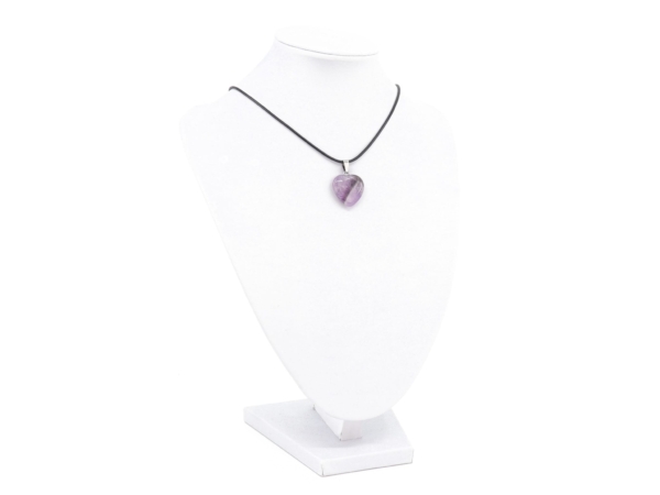 Amethyst heart gemstone pendant worn as a necklace on a white jewelry bust with black cord necklace