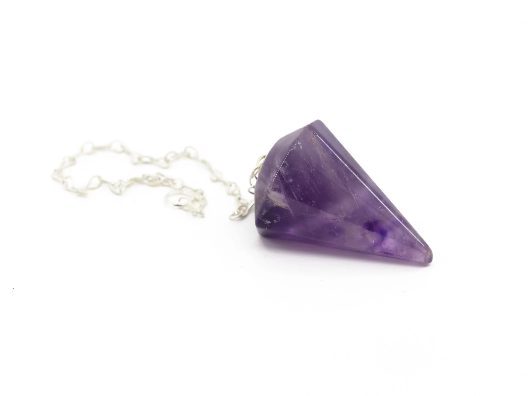 Amethyst pendulum with chain in side view, with violet grain and polished tip