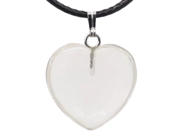 Close-up of rock crystal heart gemstone pendant with metal bail and black leather cord