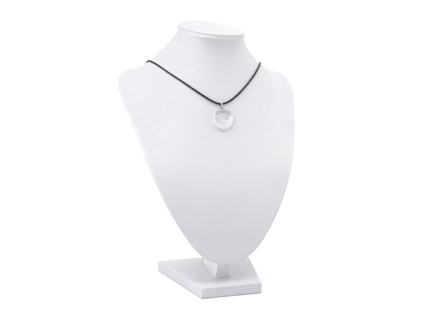 Rock crystal heart gemstone pendant on a black chain on a white jewelry bust