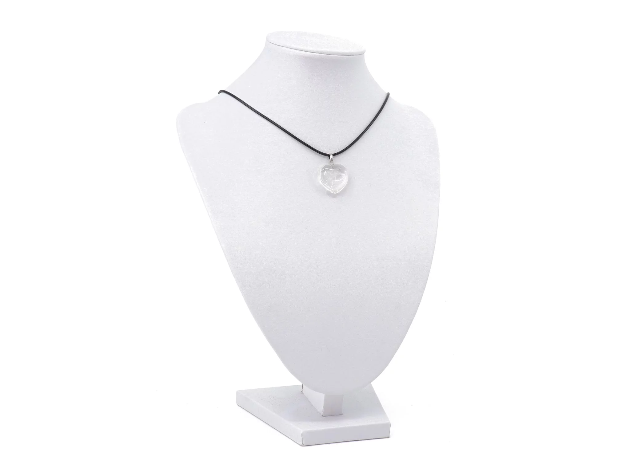 Rock crystal heart gemstone pendant on a black chain on a white jewelry bust