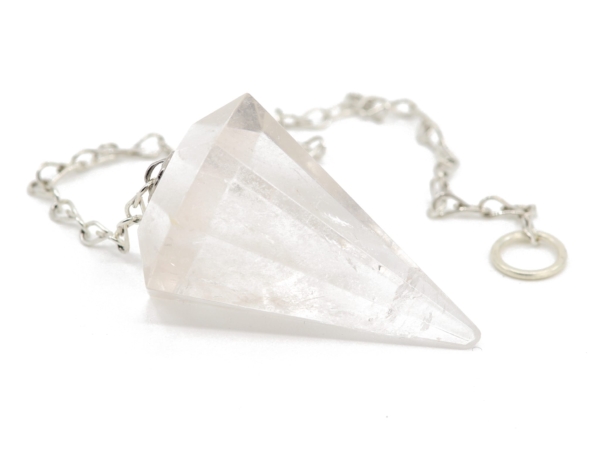 Clear quartz pendulum with faceted point and silver-colored link chain in close-up