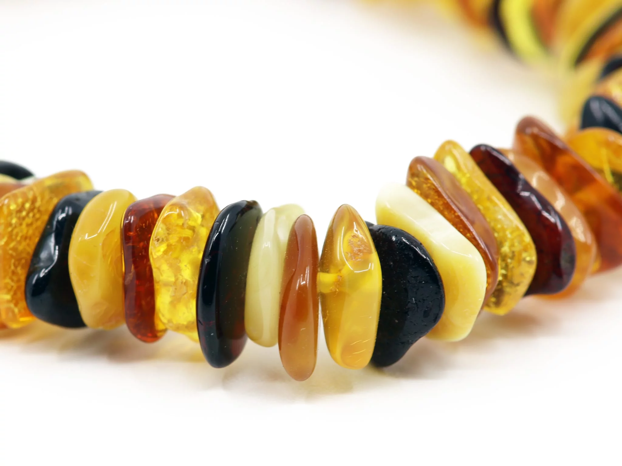 Bernstein Edelsteinarmband in Nahaufnahme mit glänzenden Bernsteinsplittern in verschiedenen Farben
