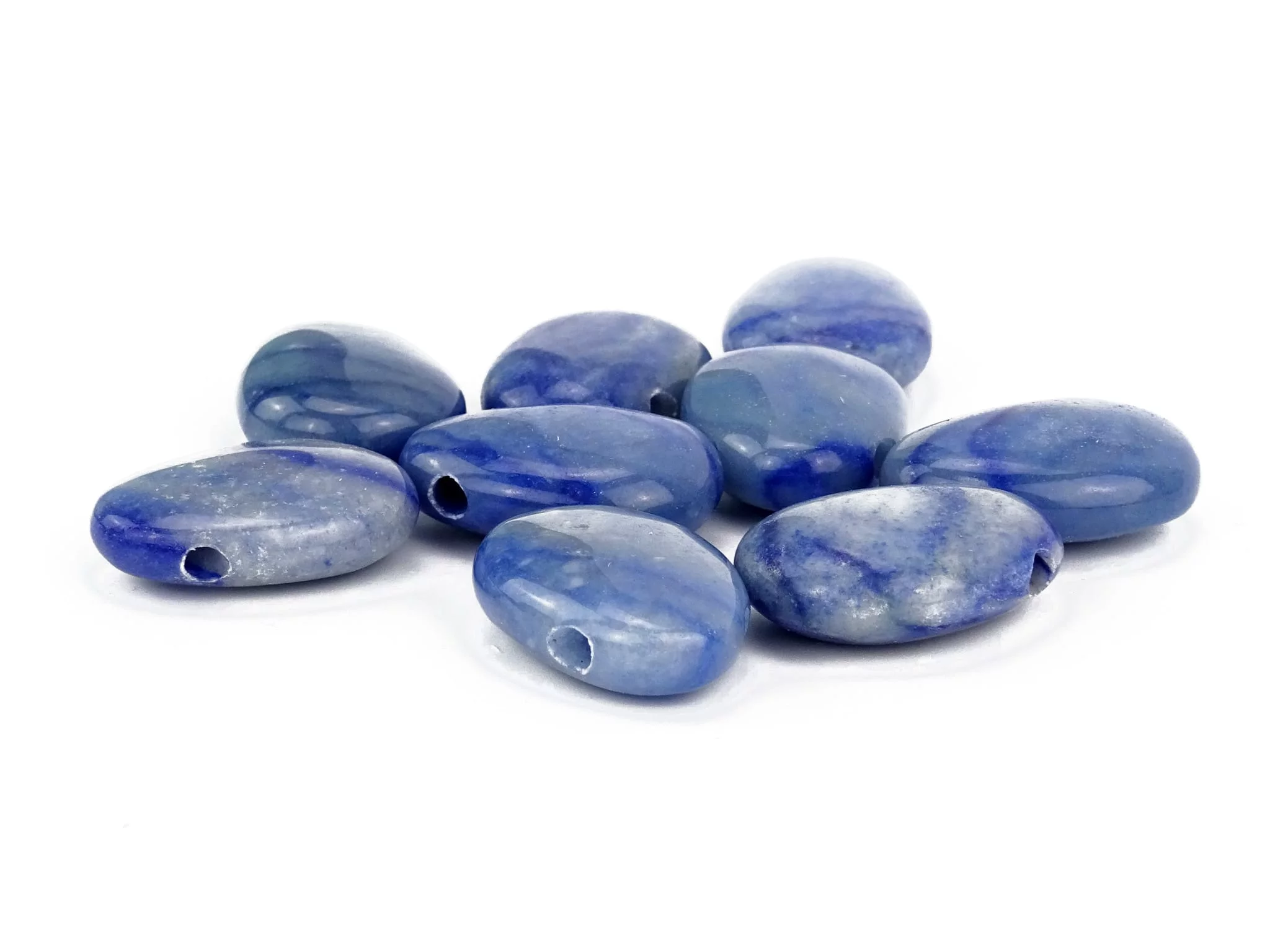 Blue quartz gemstone pendant as a close-up of several polished blue drilled stones