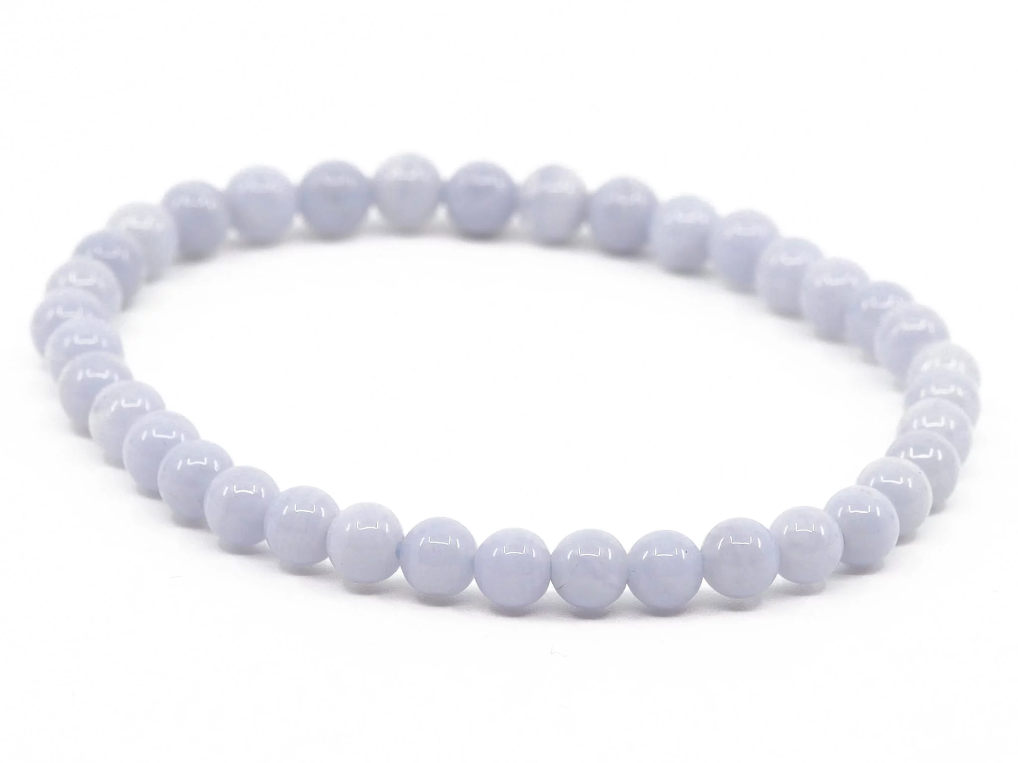 Chalcedony gemstone bracelet with light blue polished beads in an oval overall view