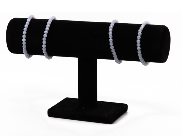 Chalcedony gemstone bracelets on a black jewelry stand with light blue beads