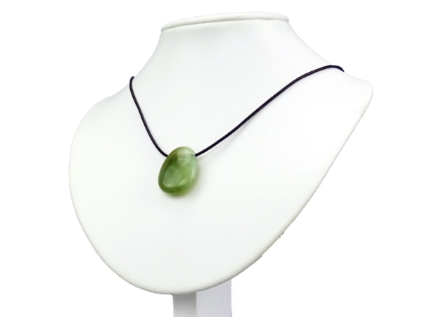 China Jade gemstone pendant as a necklace on a white jewelry bust