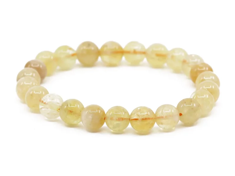 Citrin Edelsteinarmband mit glänzenden gelblichen Kugeln auf weissem Hintergrund