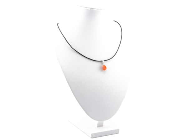 Fire opal gemstone pendant on a black necklace on a white jewellery stand