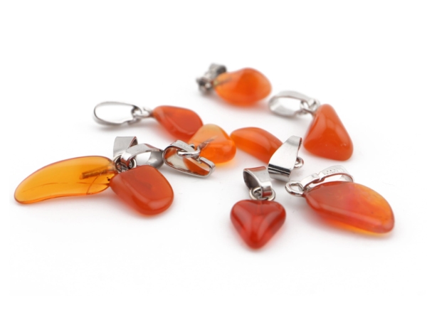 Fire opal gemstone pendant in various orange natural stone shapes with silver bails