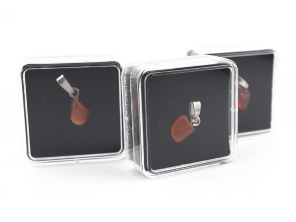 Fire opal gemstone pendant in a transparent presentation box with dark insert