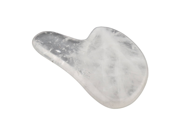 Clear quartz Gua Sha massage stone with smooth transparent surface in side view