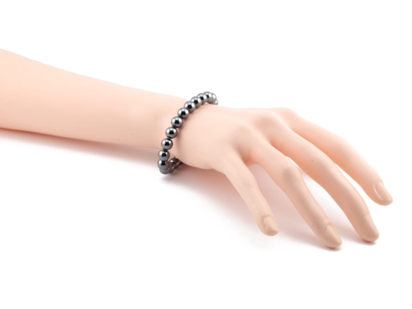 Hematite gemstone bracelet worn on wrist with metallic shiny beads