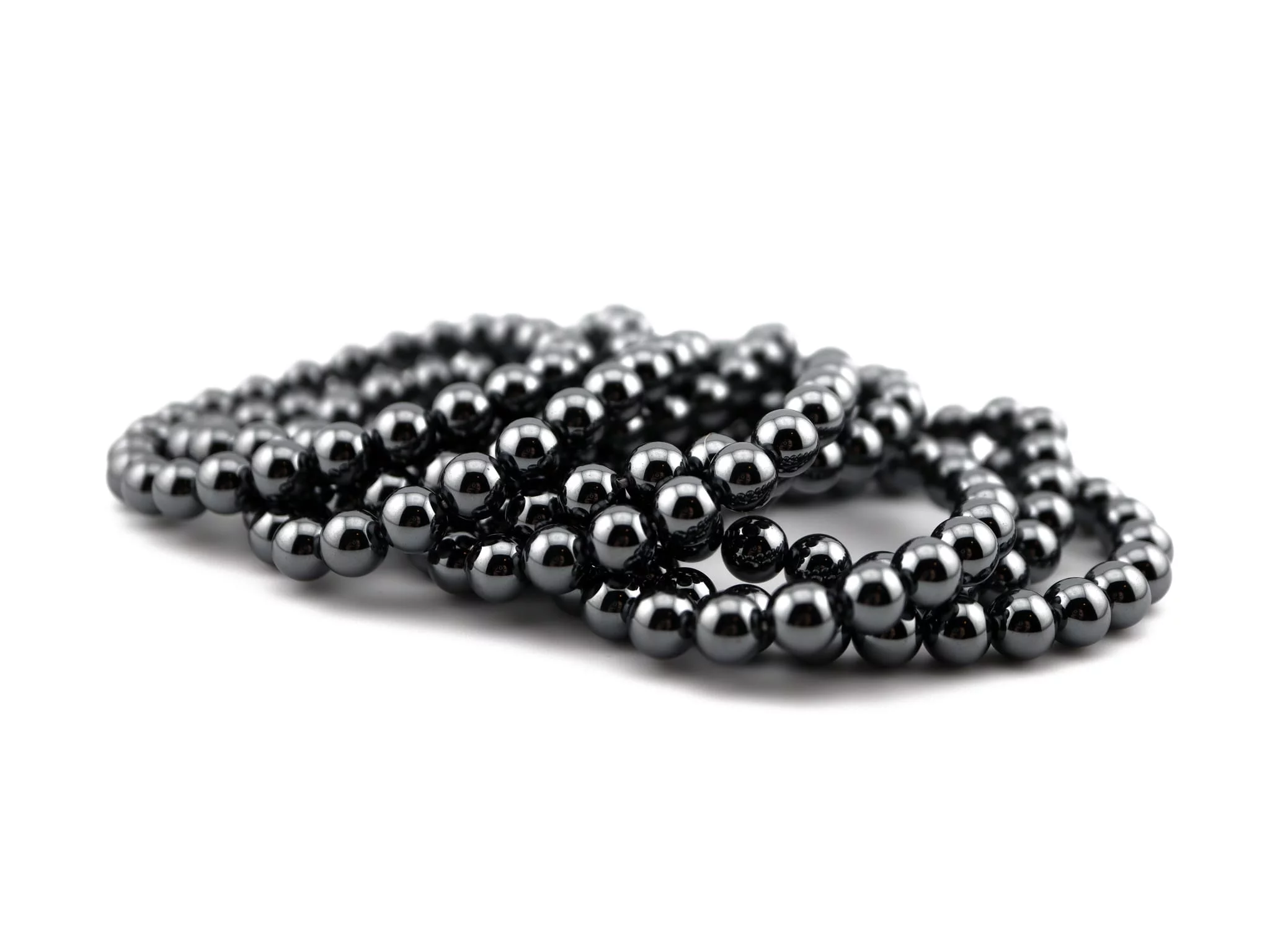 Hematite gemstone bracelets with polished dark gray beads in stacked detail view