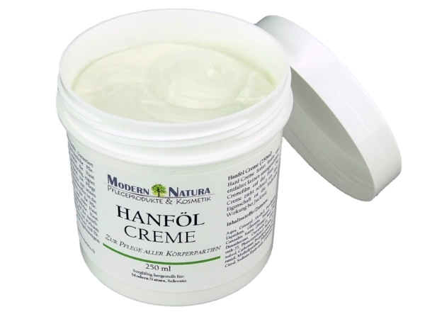 Hemp oil cream for face and body care with opened cream packaging
