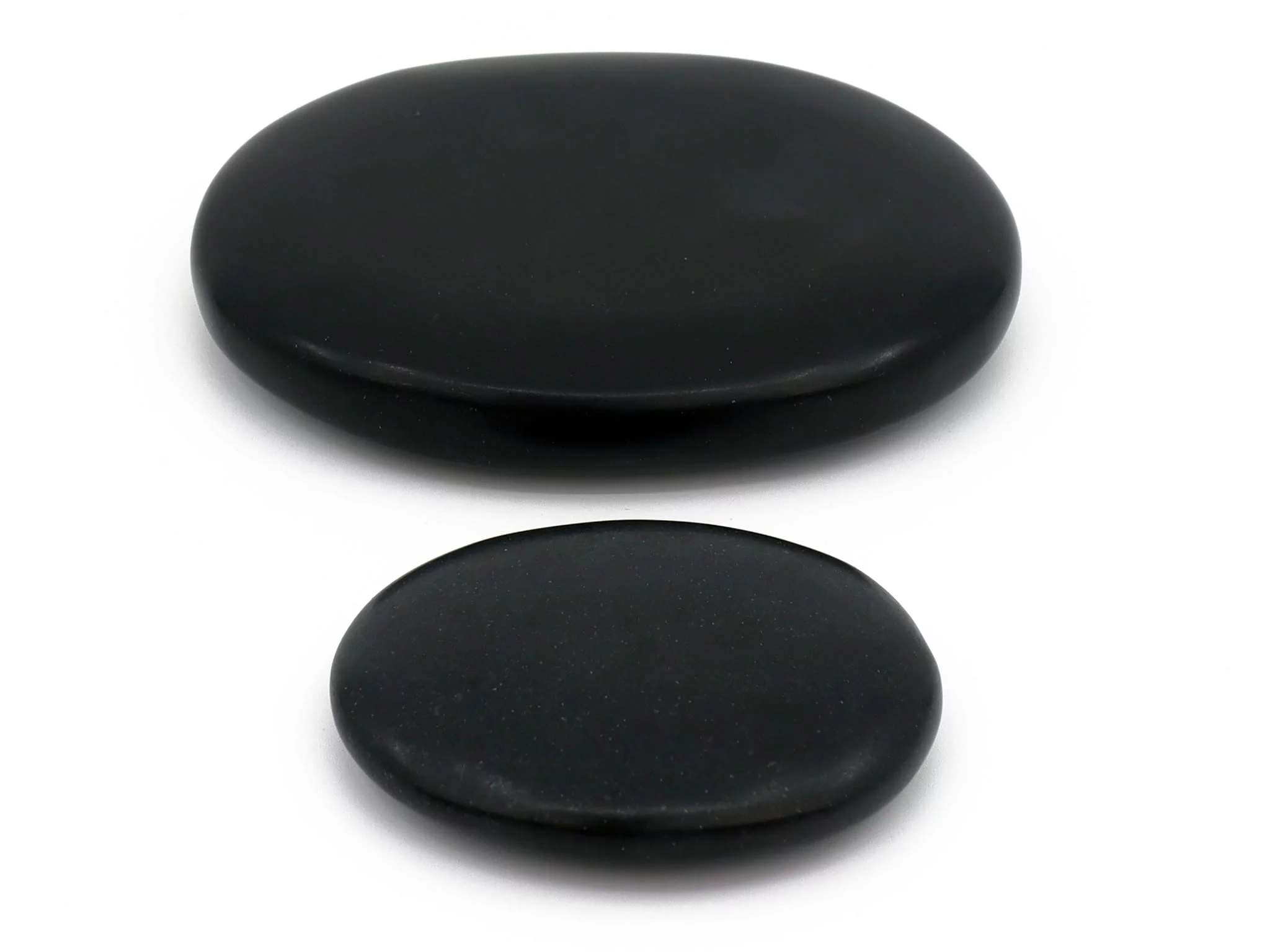 Basalt Hot Stone massage stones in two flat, black polished versions on a white background