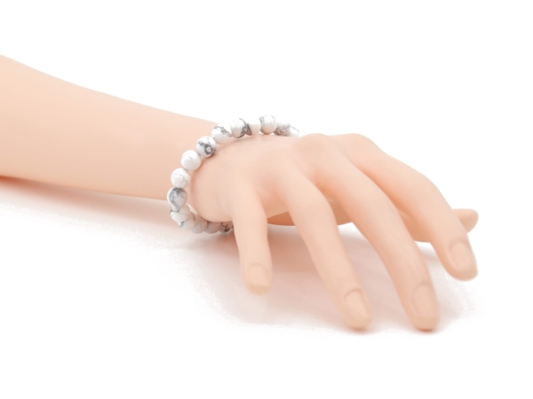 Howlite gemstone bracelet worn on the wrist with light, marbled beads