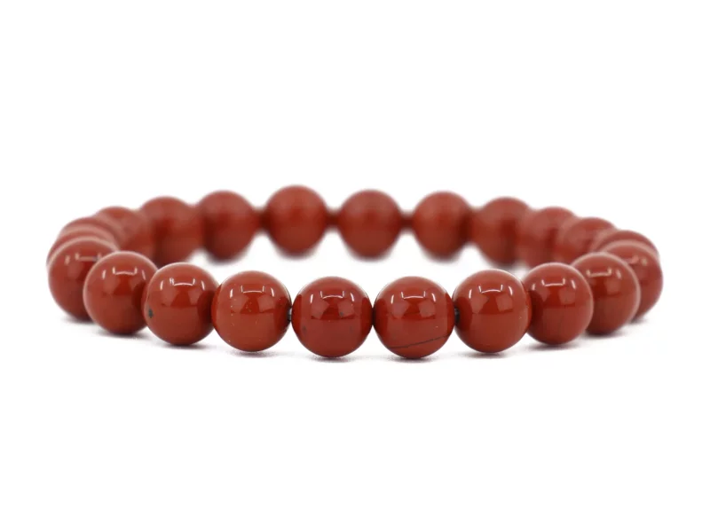 Red Jasper gemstone bracelet with shiny beads in full view on a white background