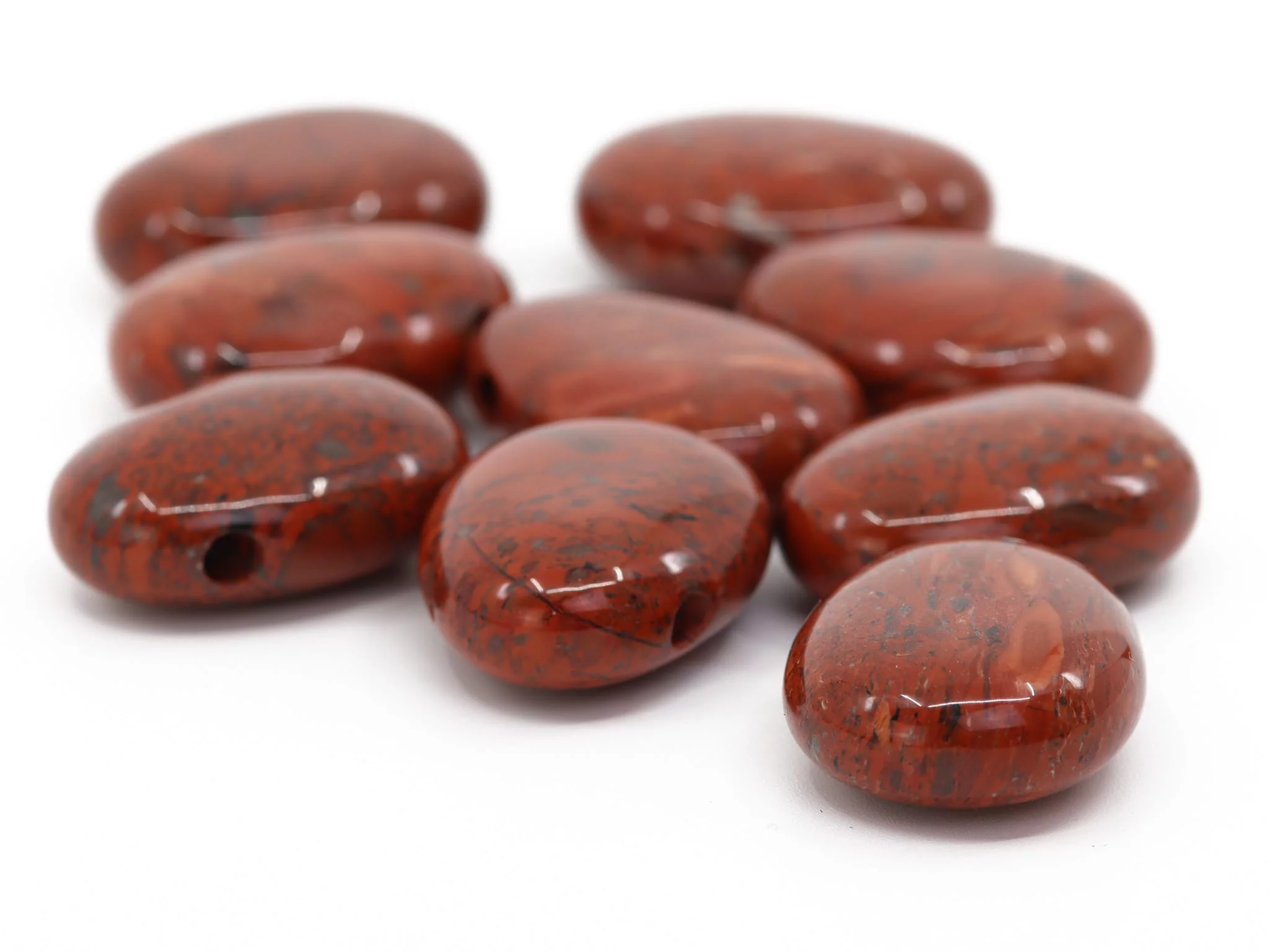 Red jasper drilled stones with polished surface and visible drillings