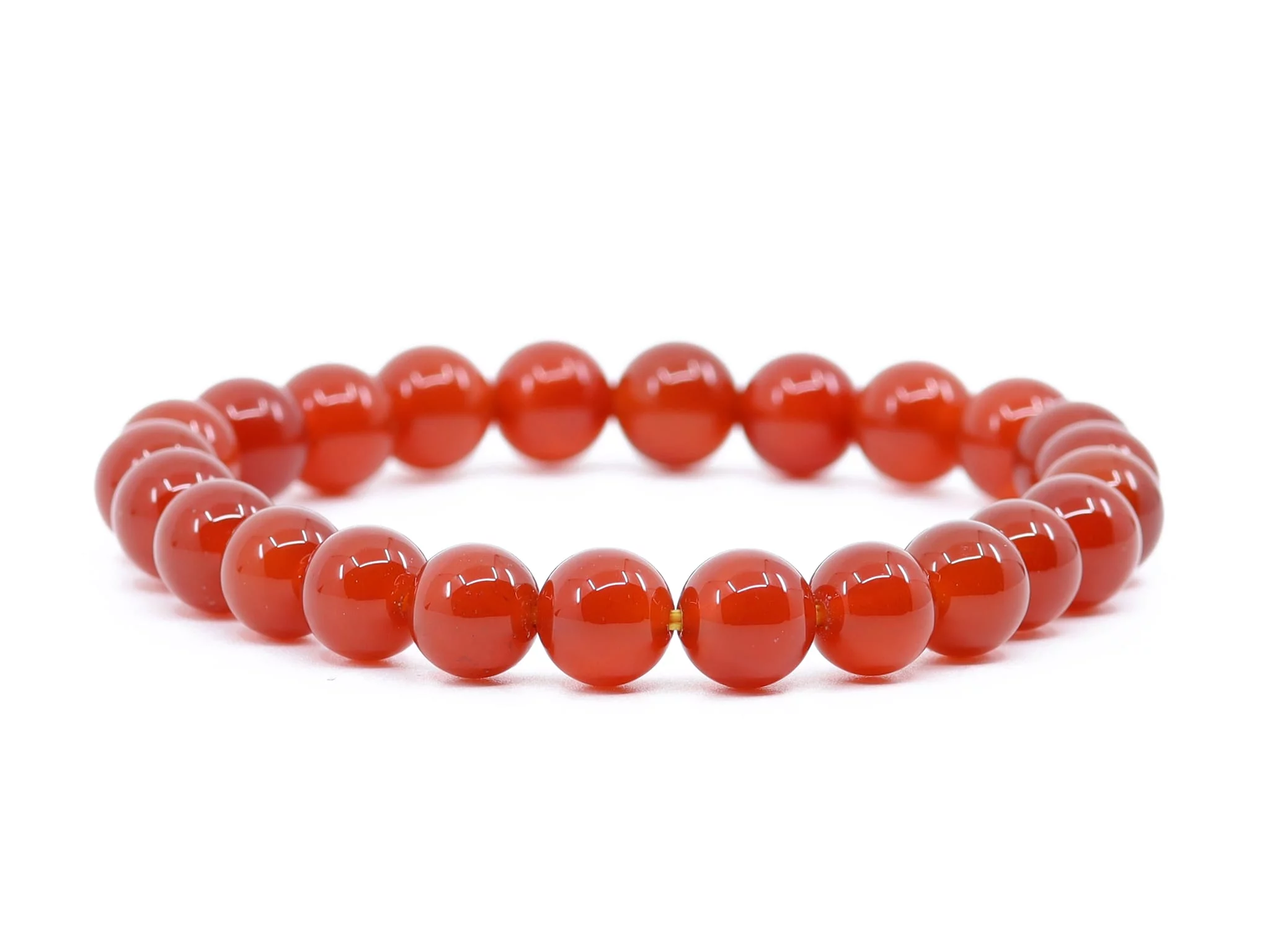 Carnelian gemstone bracelet with shiny red beads in full front view on white background