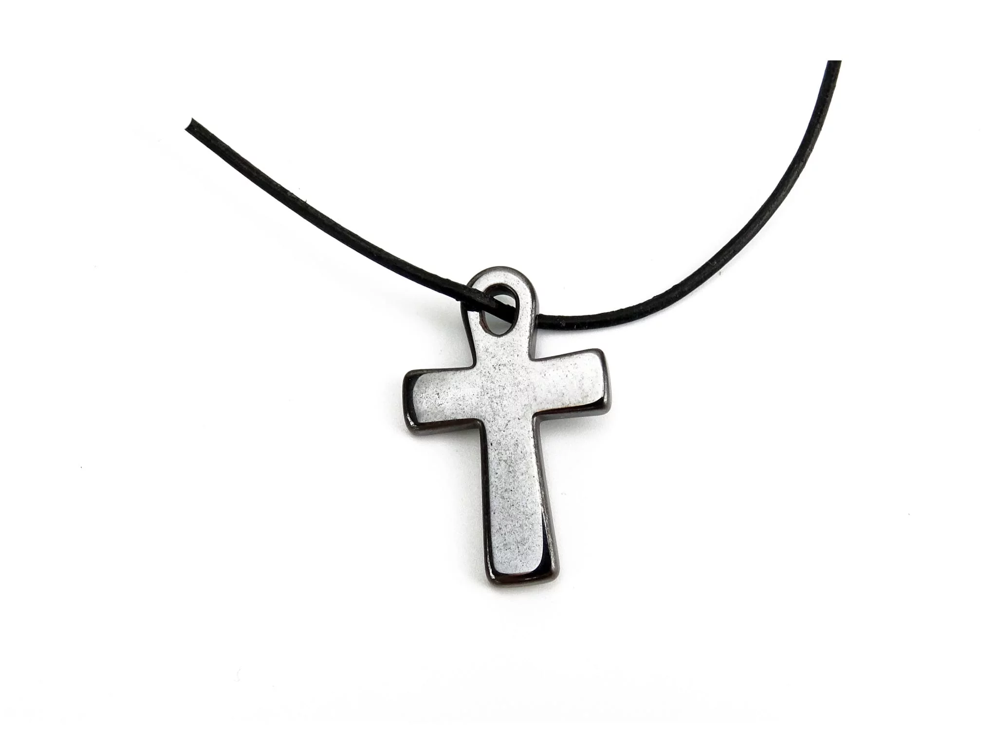 Pendentif croix en hématine sur collier noir sur fond blanc