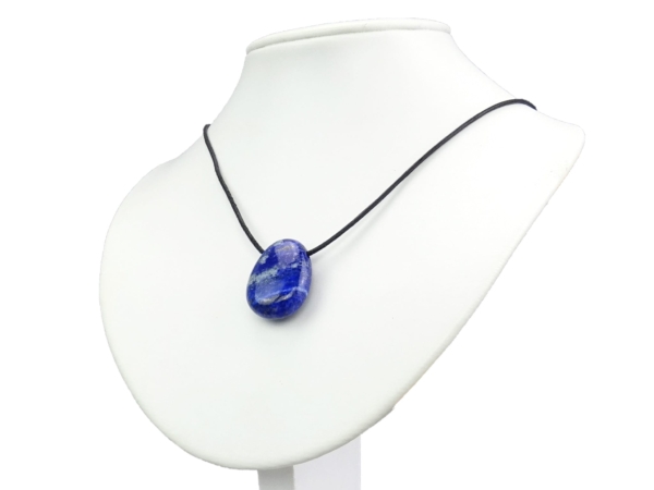Pendentif lapis-lazuli sur cordon noir sur un buste de présentation de bijoux blanc, porté