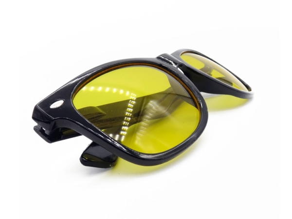Night vision glasses with black frame and yellow lenses in side close-up view