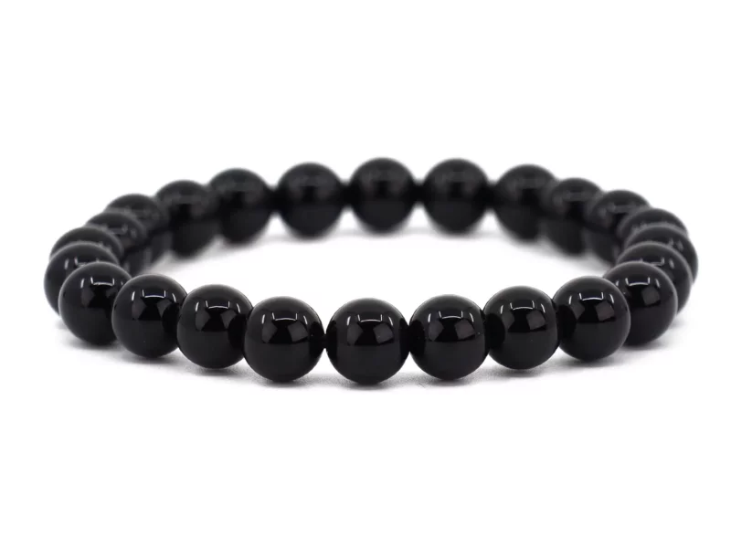 Onyx gemstone bracelet with shiny black beads in full front view on a white background
