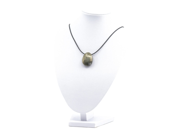 Pyrite gemstone pendant on black necklace on white jewelry stand