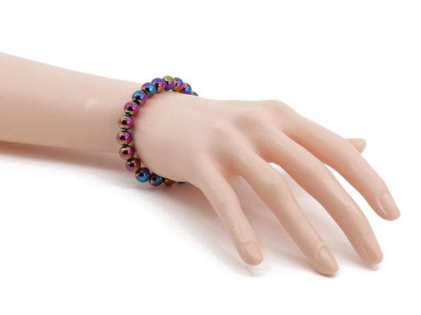 Rainbow hematite gemstone bracelet shown worn with shiny colorful beads on the wrist