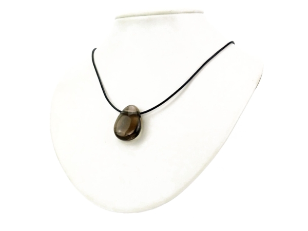 Smoky quartz gemstone pendant as a necklace on a white jewelry bust background