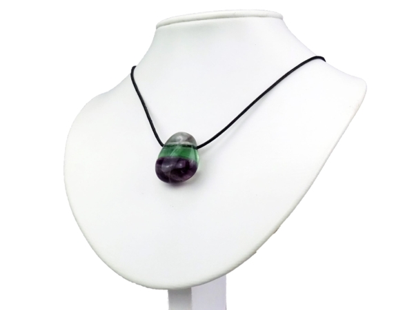 Rainbow fluorite pendant on black cord on white jewelry bust in wearing view