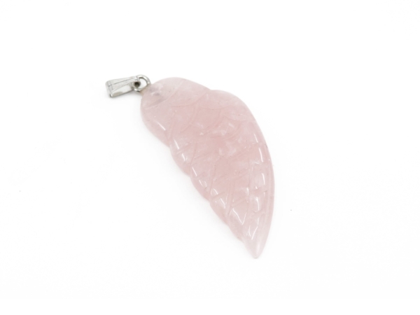 Rose quartz angel wing pendant close-up with polished light pink surface