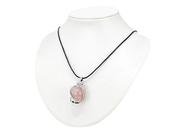 Rose quartz sphere pendant worn on a black necklace on a white jewelry bust