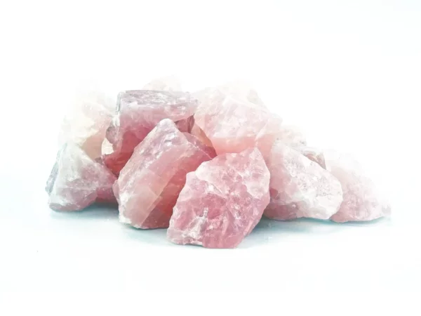 Rose Quartz Water Stones as irregular pink rough stones on a white background