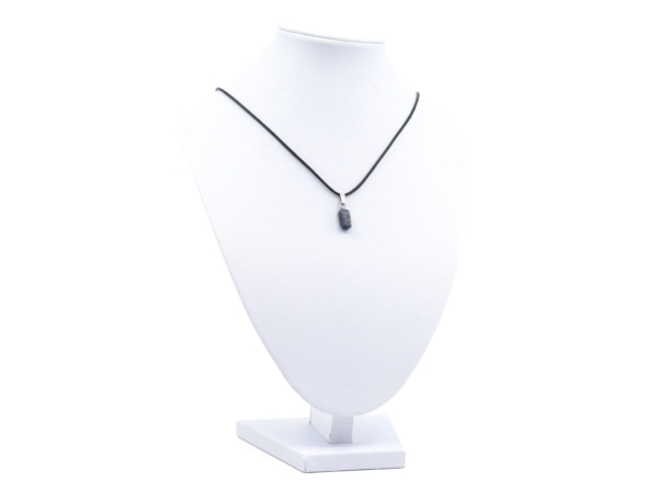 Sapphire natural crystal pendant as a necklace on a white jewelry bust stand