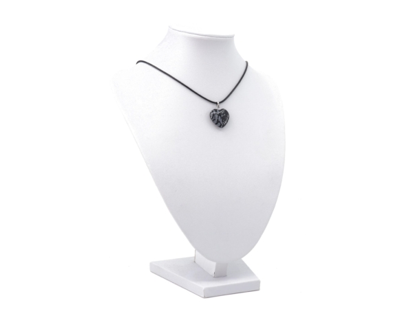 Snowflake obsidian heart pendant as a necklace on a white jewellery stand