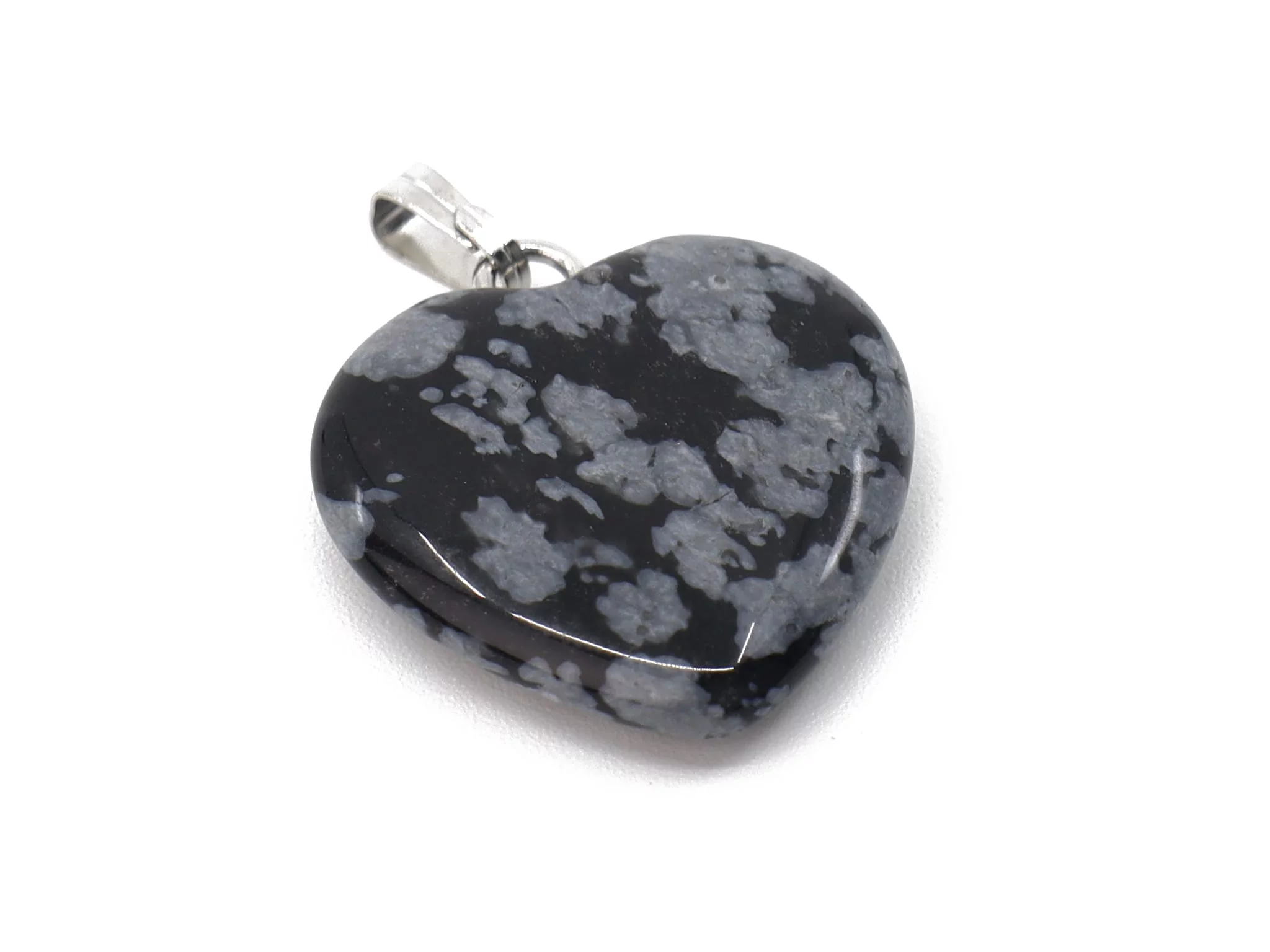 Snowflake obsidian heart pendant close-up with polished black-grey surface