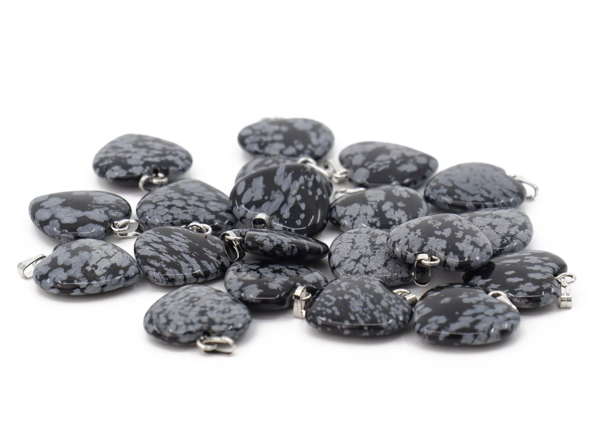 Snowflake obsidian heart pendant showing a selection of several grey-patterned natural stones