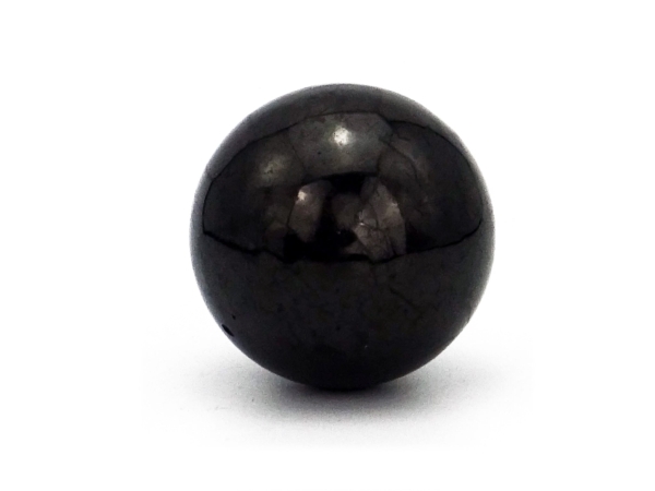 Shungite sphere as a detailed view with dark reflection on the polished surface
