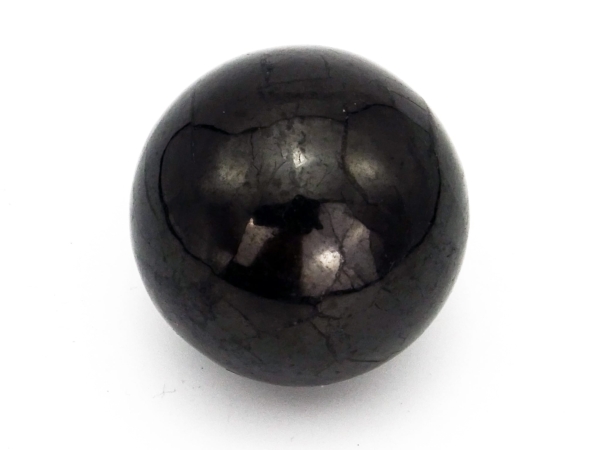 Shungite sphere in close-up view with individual natural lines and reflections