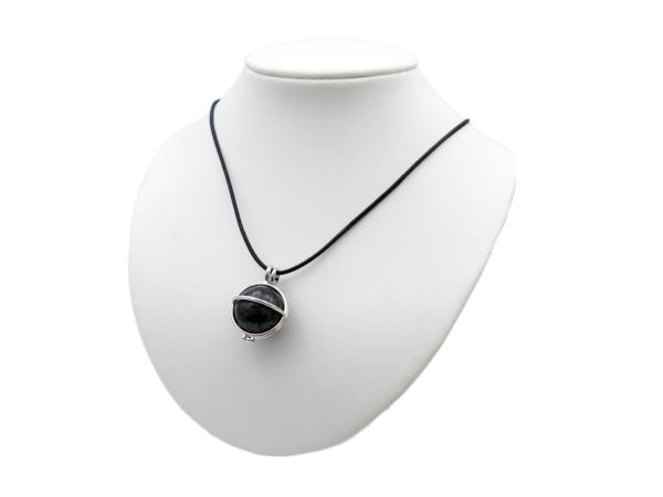 Pendentif en pierre de shungite comme collier sur un buste de bijou blanc en vue portée