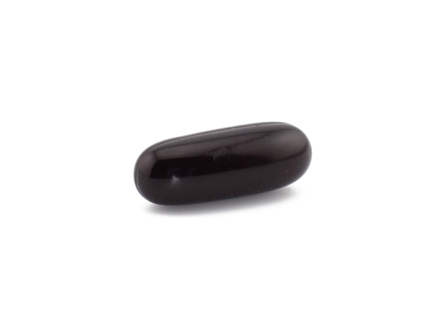 Single shilajit softgel capsule lying with a smooth, dark shiny surface