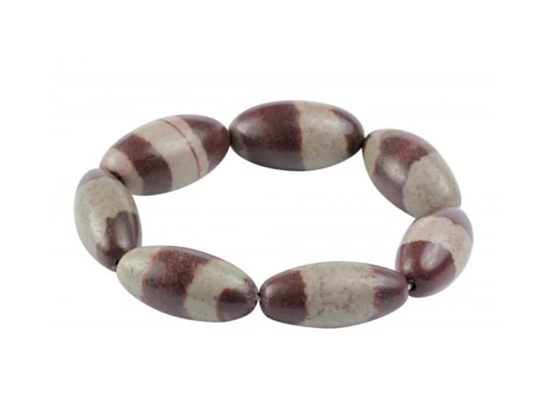 Shiva Lingam bracelet with elongated brown-beige patterned gemstones on a white background