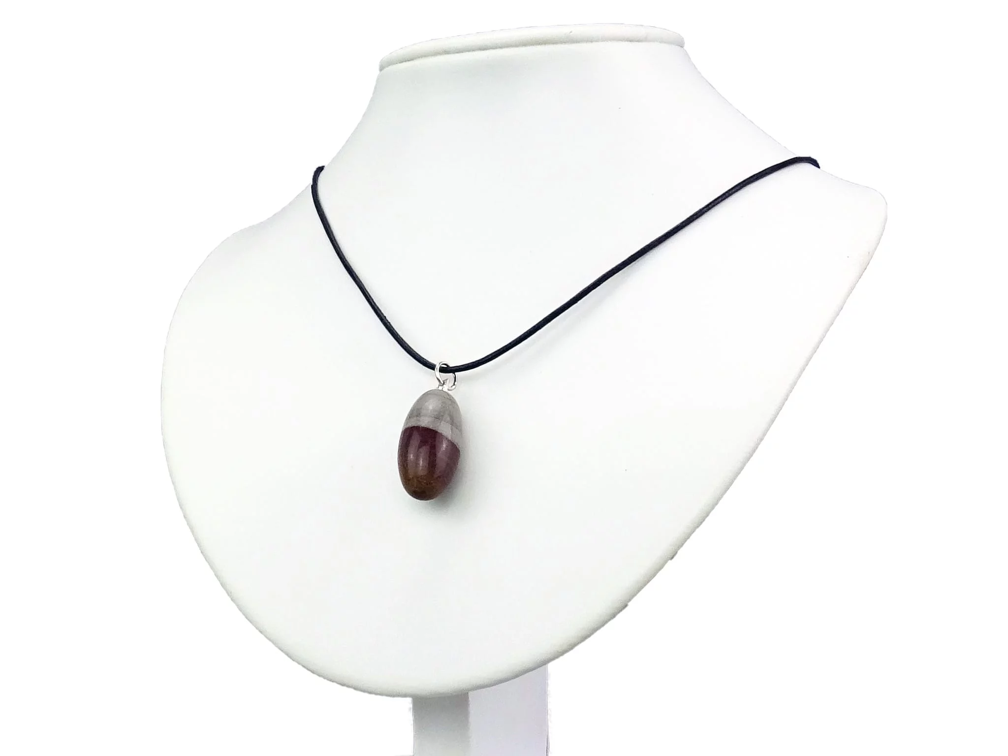Shiva Lingam gemstone pendant worn on black necklace displayed on white bust stand